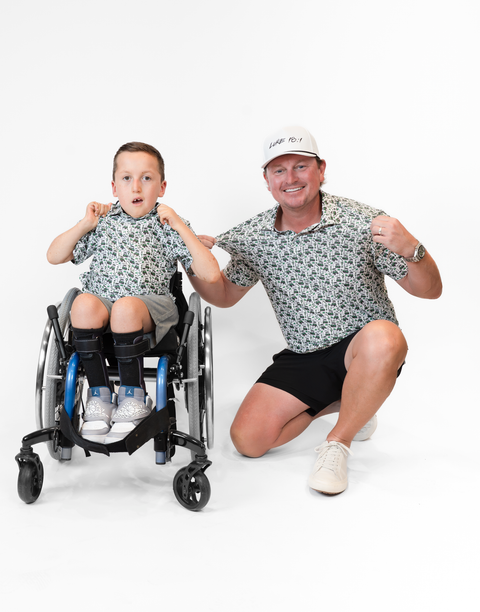 Two people wearing matching performance golf polos