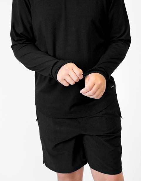 Boy wearing Youth Black Bamboo Performance Hoodie