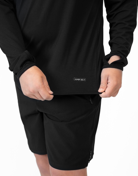 closeup of bottom front of Boy wearing Youth Black Bamboo Performance Hoodie showing "LUKE 18:1" text