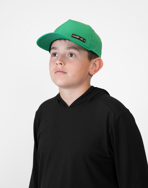 Child wearing kelly green hat with "LUKE 18:1" text