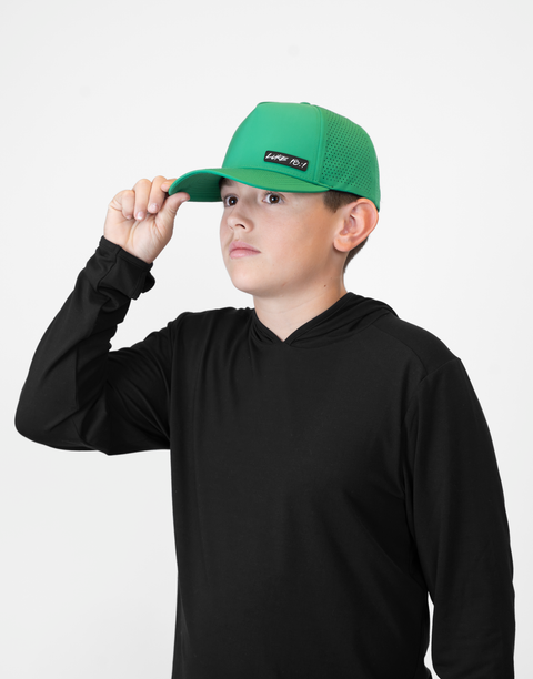 Child wearing kelly green hat with "LUKE 18:1" text
