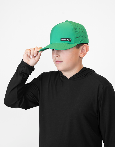 Child wearing kelly green hat with "LUKE 18:1" text