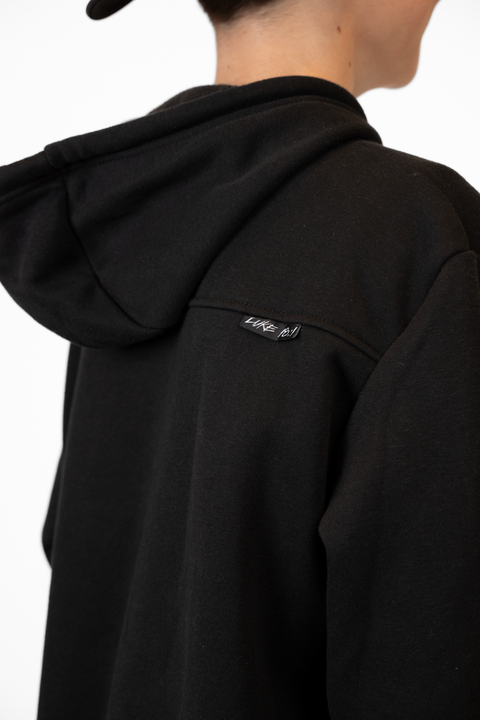 Rear view of boy wearing Youth Black Fleece Hoodie showing "LUKE 18:1" text on upper right back