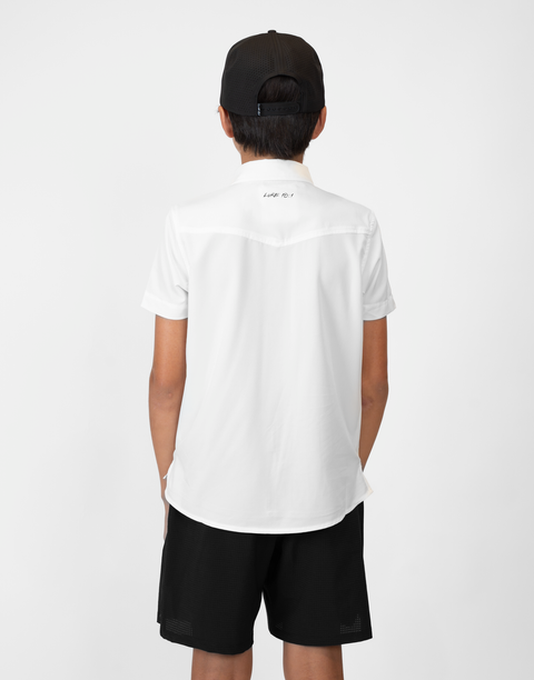 Rear view of Boy wearing Youth White S/S Pearl Snap Shirt showing "LUKE 18:1" text on upper back
