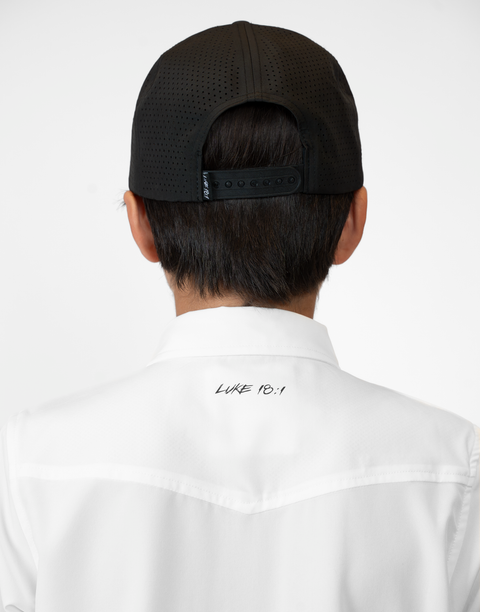 Rear view of Boy wearing Youth White S/S Pearl Snap Shirt showing "LUKE 18:1" text on upper back