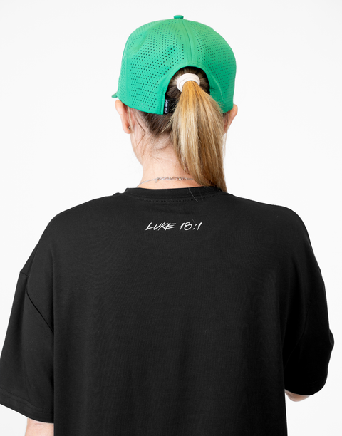 Rear view of woman wearing ladies Bamboo Mid-Crop Tee with "Luke 18:1" text on upper back