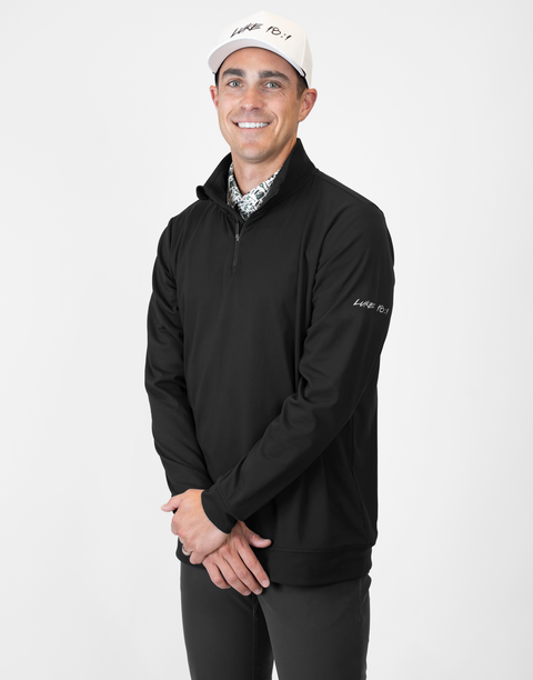 Man wearing Men's black Performance 1/4-Zip with "LUKE 18:1" text on sleeve