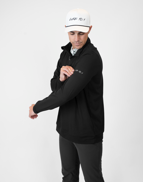 Man wearing Men's black Performance 1/4-Zip with "LUKE 18:1" text on sleeve