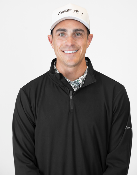 Man wearing Men's black Performance 1/4-Zip with "LUKE 18:1" text on sleeve