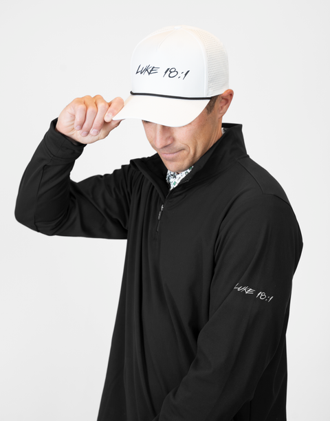 Man wearing Men's black Performance 1/4-Zip with "LUKE 18:1" text on sleeve