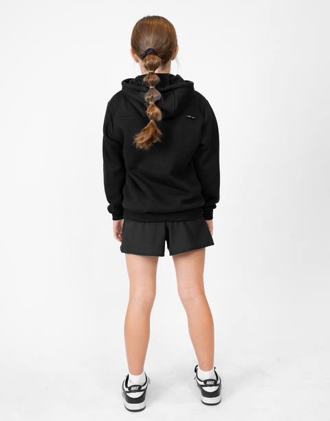 Rear view of girl wearing girls black flowy performance short