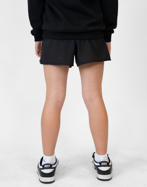 Rear view of girl wearing girls black flowy performance short