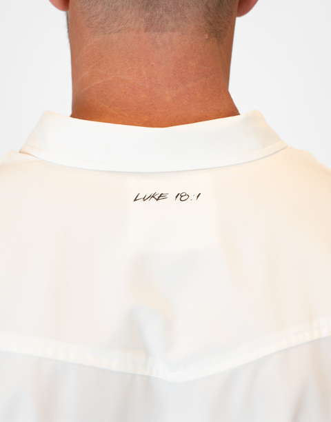 rear view of Man wearing Men's White S/S Pearl Snap Shirt showing "LUKE 18:1" text on upper back