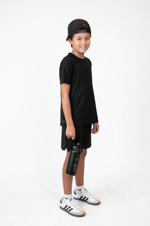 Person holding a black water bottle with 'Luke 18:1' text on a white background