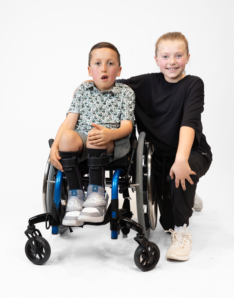 Boy and girl with Boy wearing Youth Performance Golf Polo