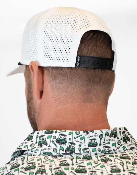 rear view of person wearing white hat showing back mesh and adjustable strap