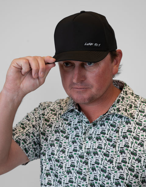man wearing black hat with "LUKE 18:1" text