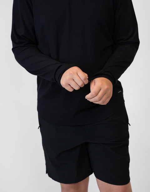 Boy wearing Youth Black Bamboo Performance Hoodie