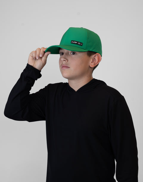 Child wearing kelly green hat with "LUKE 18:1" text