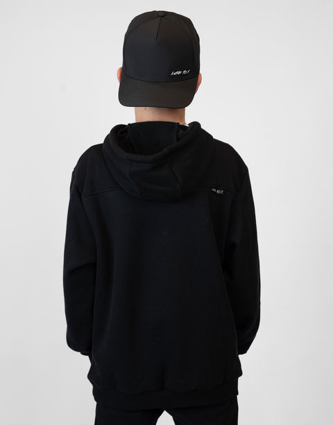Rear view of boy wearing Youth Black Fleece Hoodie showing "LUKE 18:1" text on upper right back