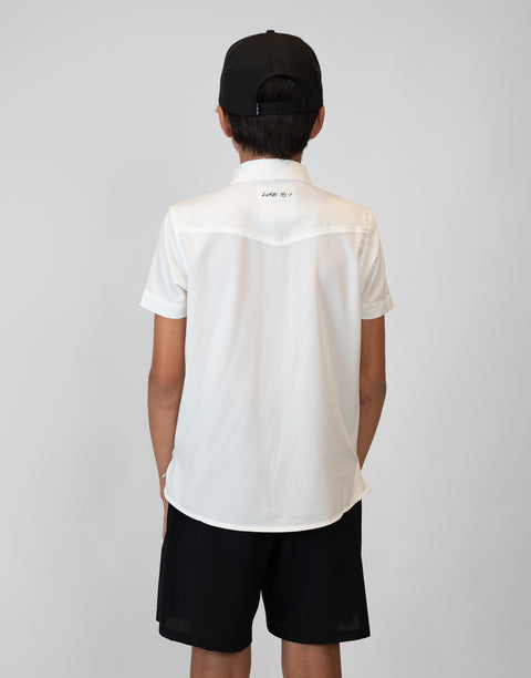 Rear view of Boy wearing Youth White S/S Pearl Snap Shirt showing "LUKE 18:1" text on upper back