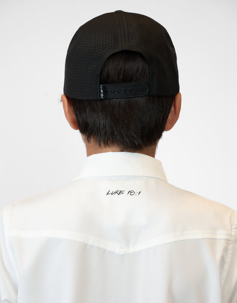 Rear view of Boy wearing Youth White S/S Pearl Snap Shirt showing "LUKE 18:1" text on upper back