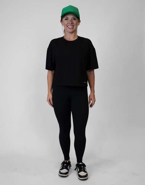 Woman wearing ladies Bamboo Mid-Crop Tee with "Luke 18:1" text above bottom seam