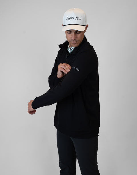 Man wearing Men's black Performance 1/4-Zip with "LUKE 18:1" text on sleeve