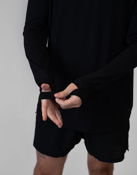 Man wearing Men's Black Bamboo Performance Hoodie showing thumb holes