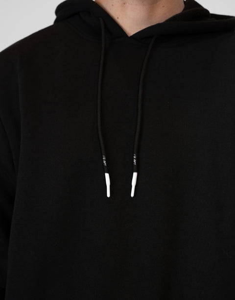 Man wearing Men's Black Fleece Hoodie showing white tips and "LUKE 18:1" text on drawstring