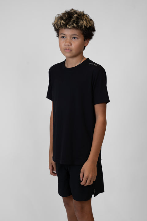 Boy wearing Youth black Bamboo Performance Tee with "LUKE 18:1" text on shoulder