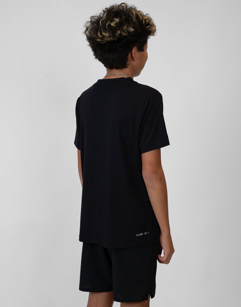 Rear view of boy wearing Youth black Bamboo Performance Tee with "LUKE 18:1" text on back above lower seam