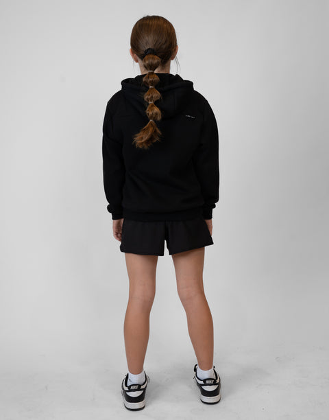 Rear view of girl wearing girls black flowy performance short