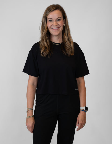 Woman wearing ladies Bamboo Mid-Crop Tee with "Luke 18:1" text above lower seam