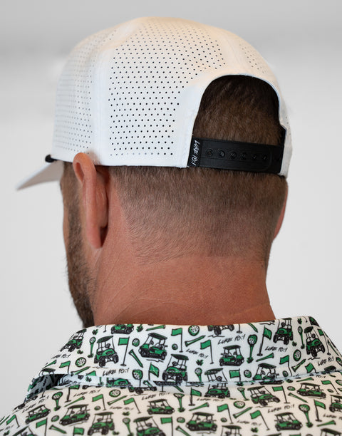 rear view of person wearing white hat showing back mesh and adjustable strap