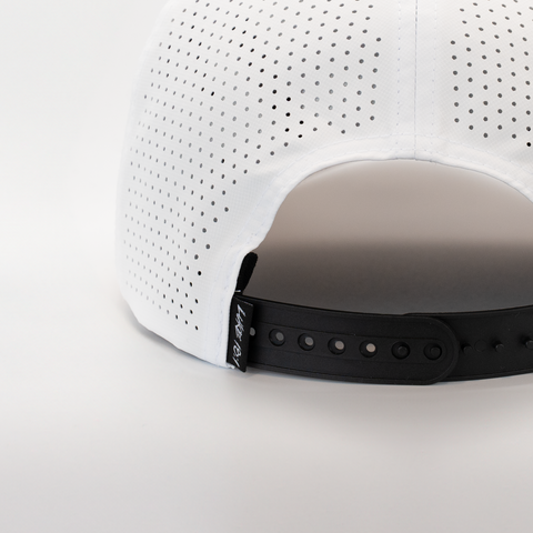 Rear view of white hat with black and white "LUKE 18:1" label on back