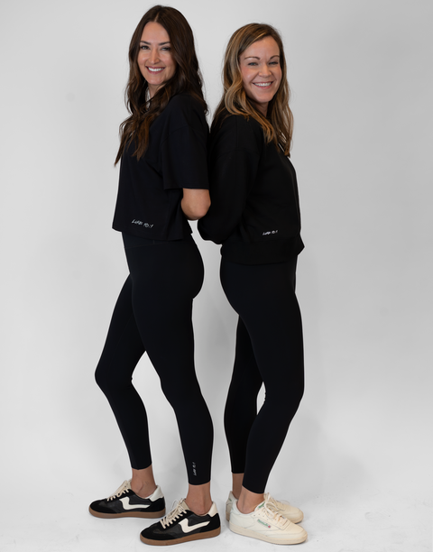 Two women wearing black Ladies Performance Legging