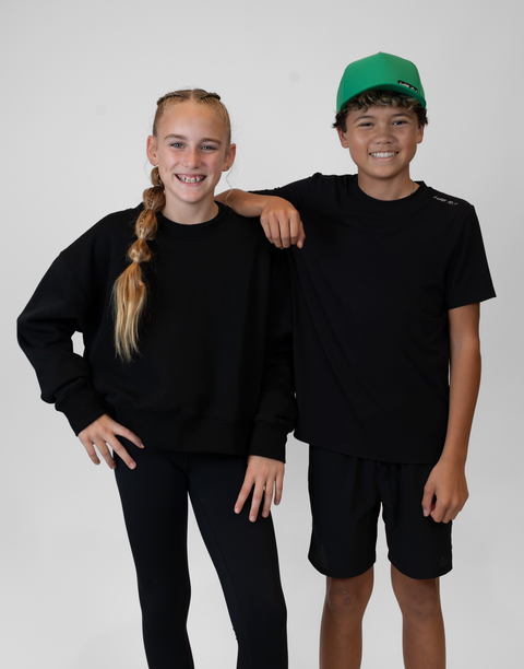 two people with one wearing Youth black Bamboo Performance Tee with "LUKE 18:1" text on shoulder