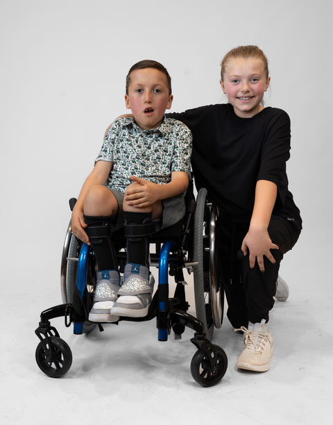 Boy and girl with Boy wearing Youth Performance Golf Polo