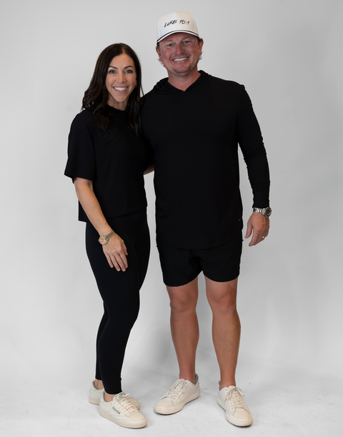 Woman and man with man wearing men's black performance hoodie