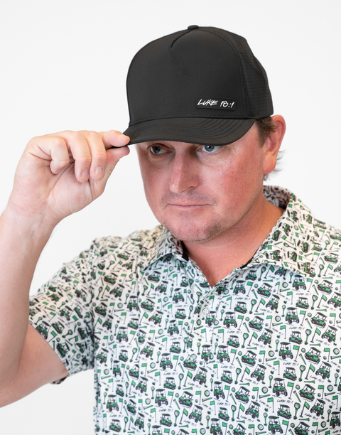 man wearing black hat with "LUKE 18:1" text
