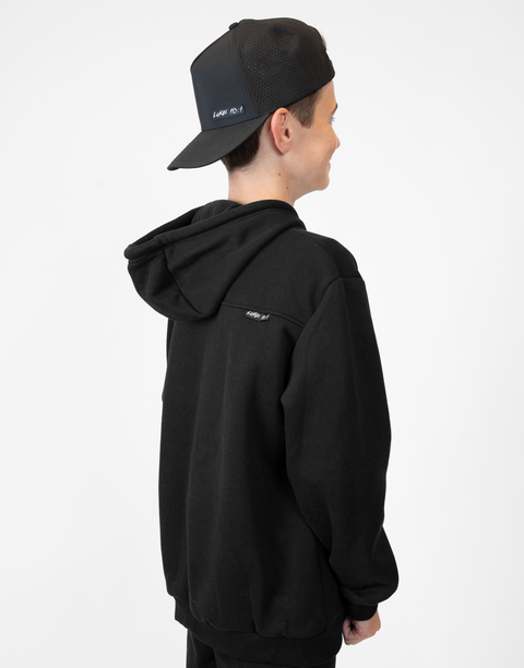 Rear view of boy wearing Youth Black Fleece Hoodie showing "LUKE 18:1" text on  upper right back