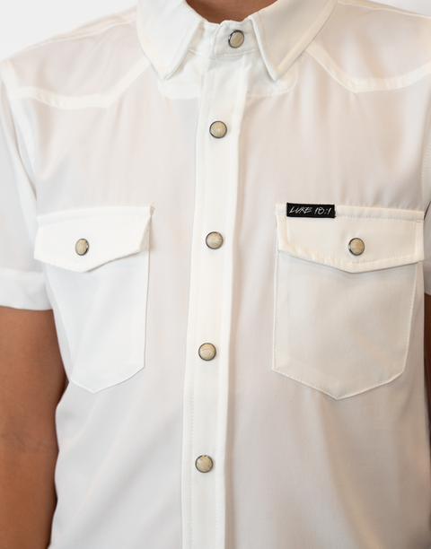 Boy wearing Youth White S/S Pearl Snap Shirt showing "LUKE 18:1" text on pocket