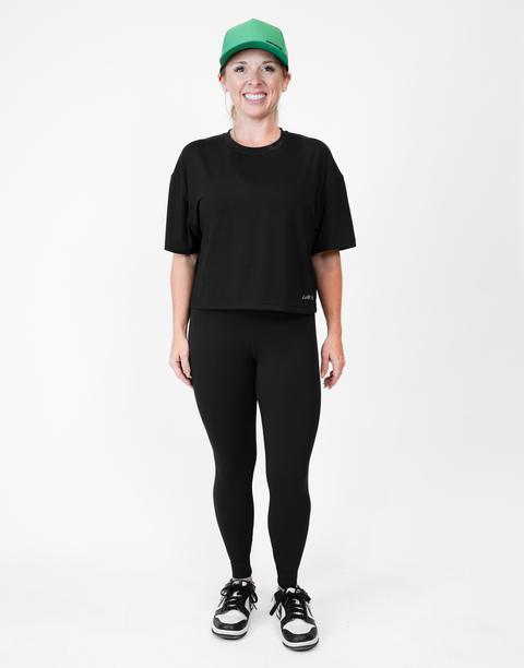 Woman wearing ladies Bamboo Mid-Crop Tee with "Luke 18:1" text above bottom seam