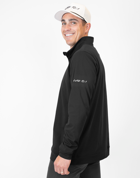 side view of Man wearing Men's black Performance 1/4-Zip with "LUKE 18:1" text on sleeve