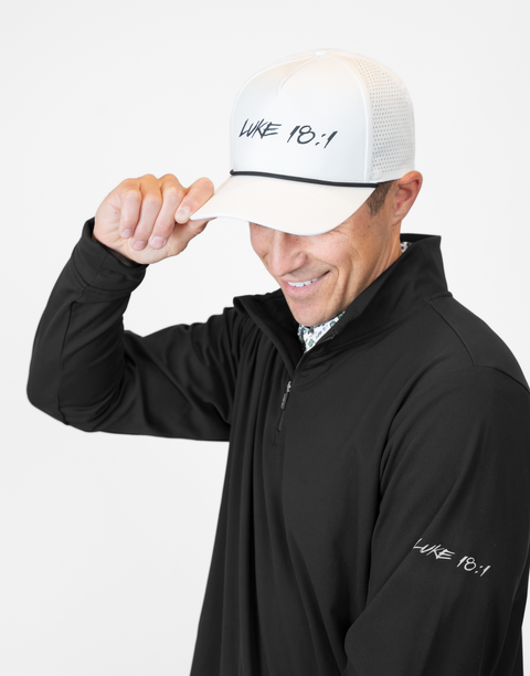 Man wearing Men's black Performance 1/4-Zip with "LUKE 18:1" text on sleeve