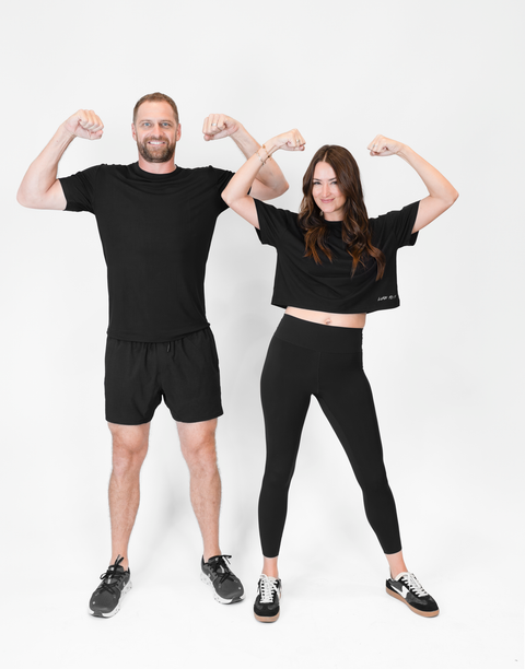 man and woman flexing with woman wearing black Ladies Performance Legging