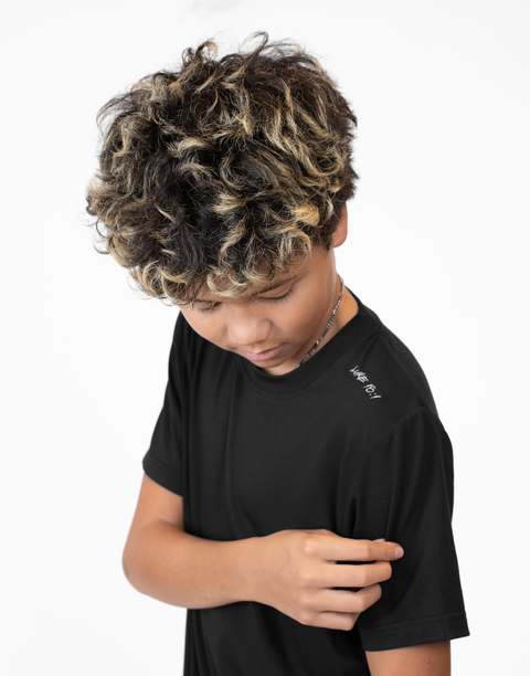 Boy wearing Youth black Bamboo Performance Tee with "LUKE 18:1" text on shoulder