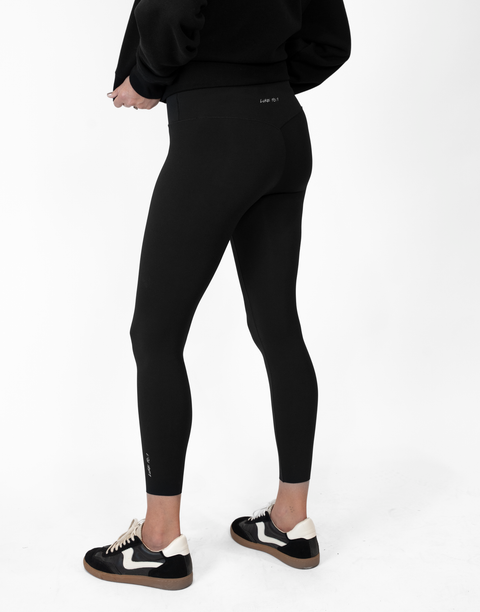 rear view of person wearing black Ladies Performance Legging with "LUKE 18:1" text on waistband