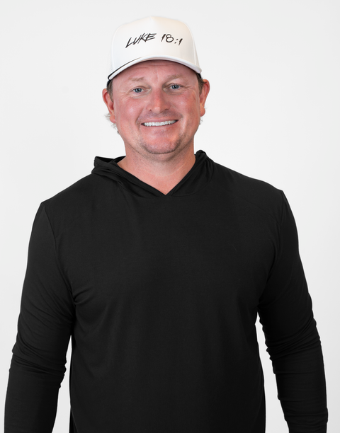 Person wearing white hat with black "LUKE 18:1" text